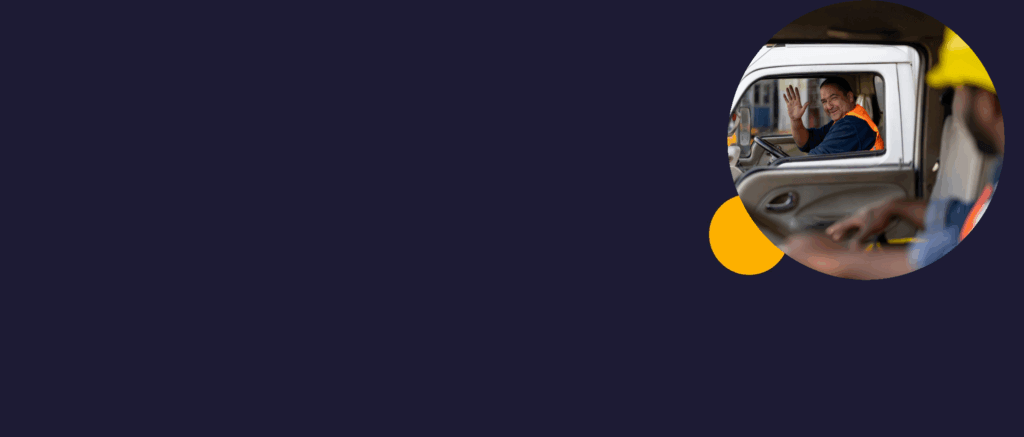 Happy truck driver greeting another one while driving