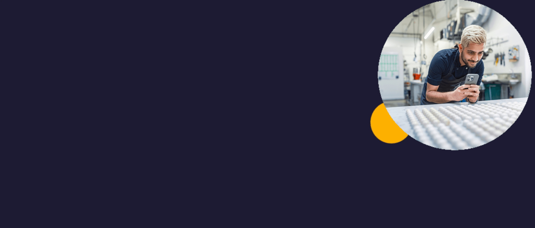 Young south Asian man taking a photo on his phone of some baking he's done.